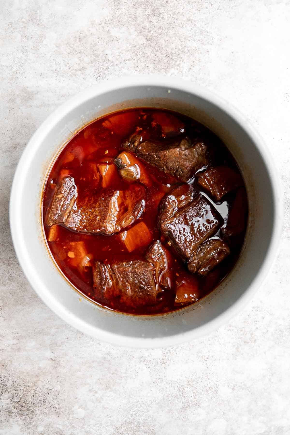 Instant Pot Short Ribs are rich, tender, and delicious. These short ribs fall-off-the-bone after being braised in a red wine broth in the pressure cooker. | aheadofthyme.com
