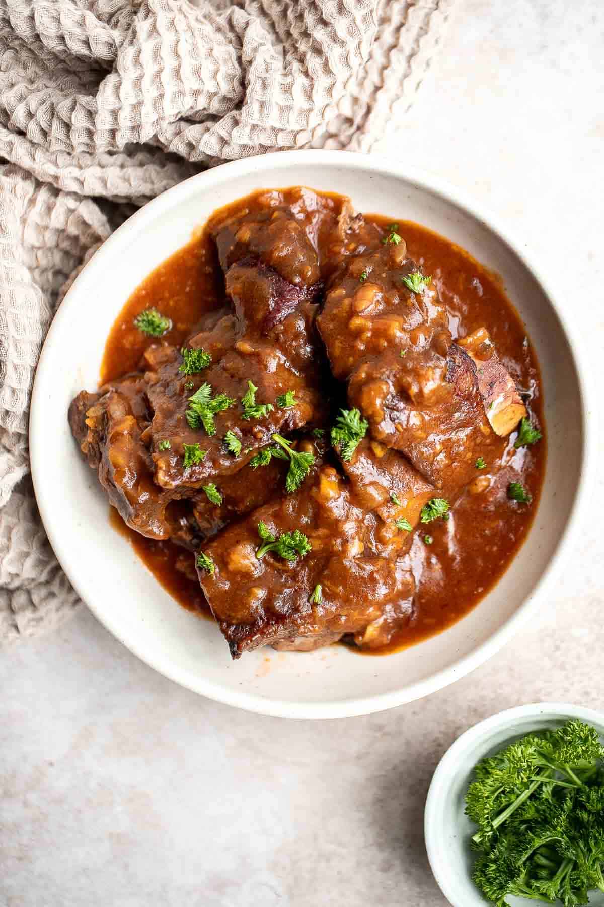 Instant Pot Short Ribs are rich, tender, and delicious. These short ribs fall-off-the-bone after being braised in a red wine broth in the pressure cooker. | aheadofthyme.com