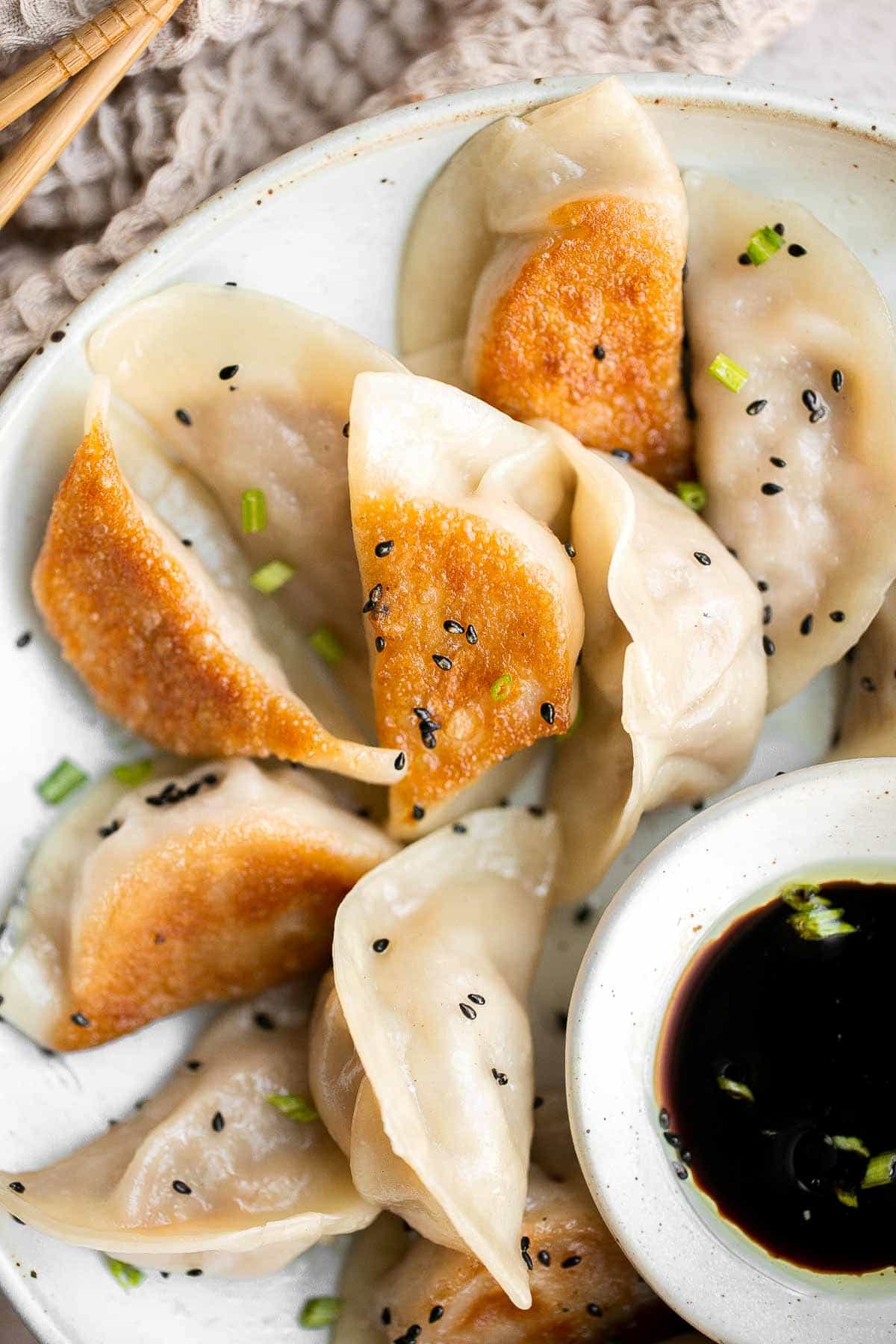 Kimchi Dumplings are savory, delicious, and flavorful. These Korean-inspired dumplings get seared and steamed to create classic crispy bottom potstickers. | aheadofthyme.com