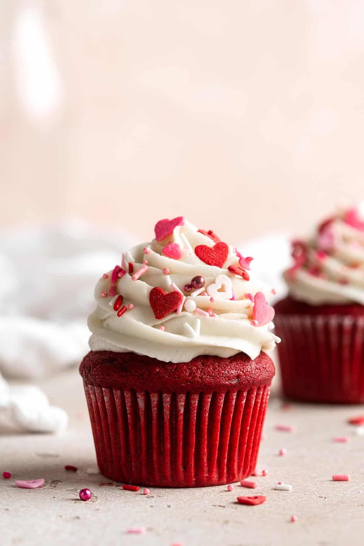 These Red Velvet Cupcakes with cream cheese frosting are delicious, moist, rich, and perfectly sweet. Top these Valentine’s cupcakes with festive sprinkles. | aheadofthyme.com