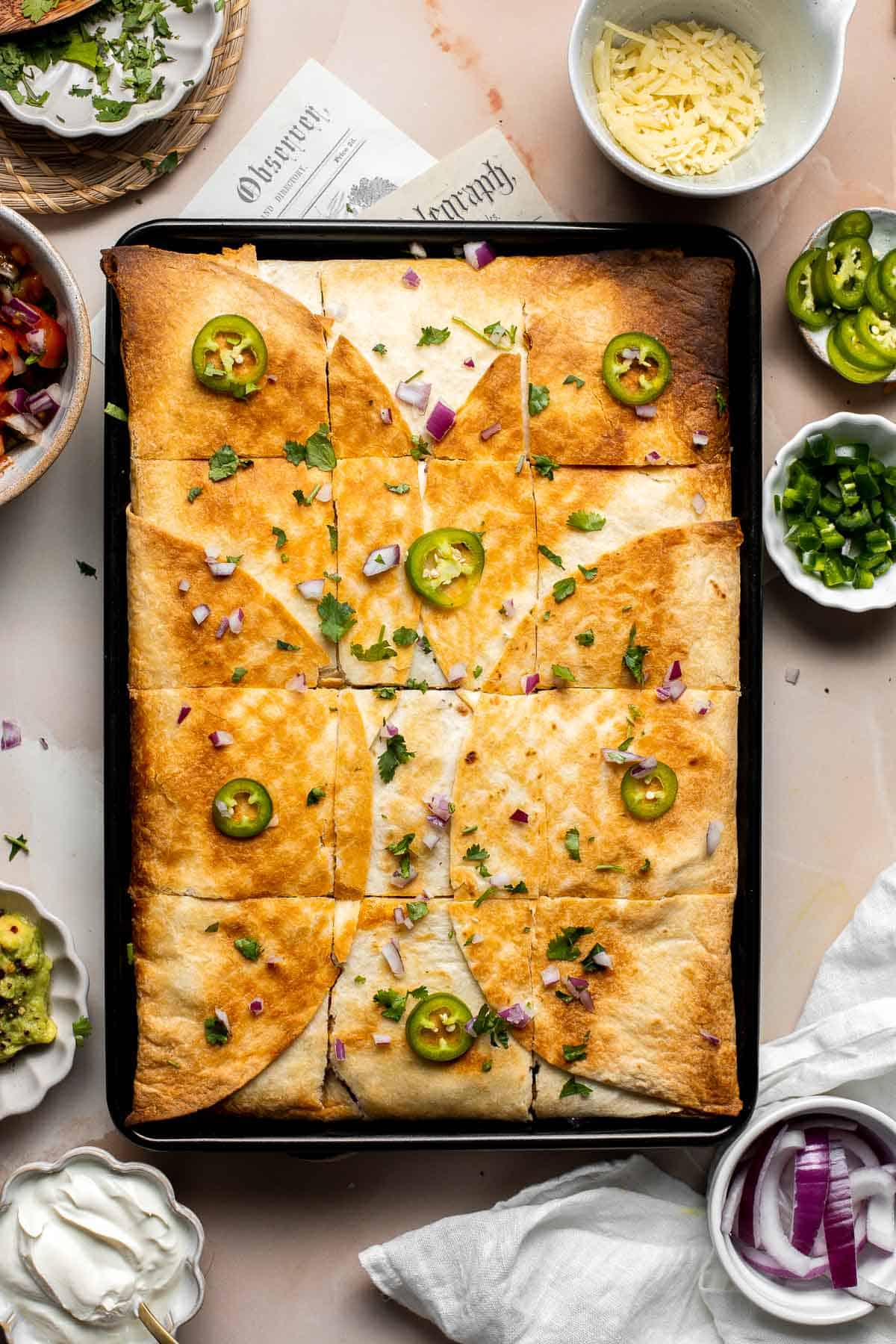 These Sheet Pan Quesadillas are loaded with veggies and gooey cheese, baked in the oven until crispy, and made to feed a crowd in just 30 minutes. | aheadofthyme.com