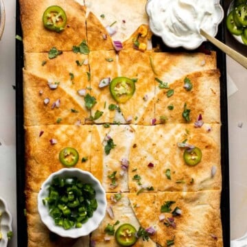 These Sheet Pan Quesadillas are loaded with veggies and gooey cheese, baked in the oven until crispy, and made to feed a crowd in just 30 minutes. | aheadofthyme.com