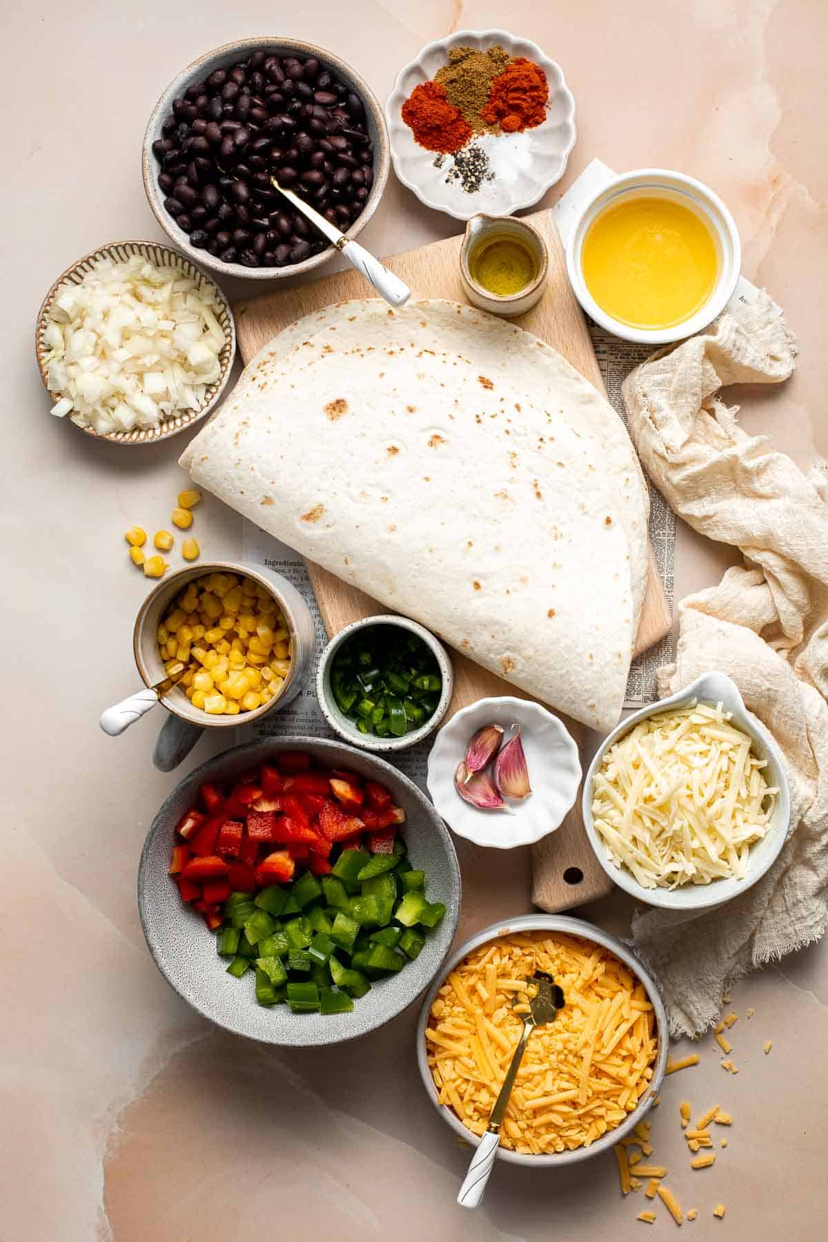 These Sheet Pan Quesadillas are loaded with veggies and gooey cheese, baked in the oven until crispy, and made to feed a crowd in just 30 minutes. | aheadofthyme.com