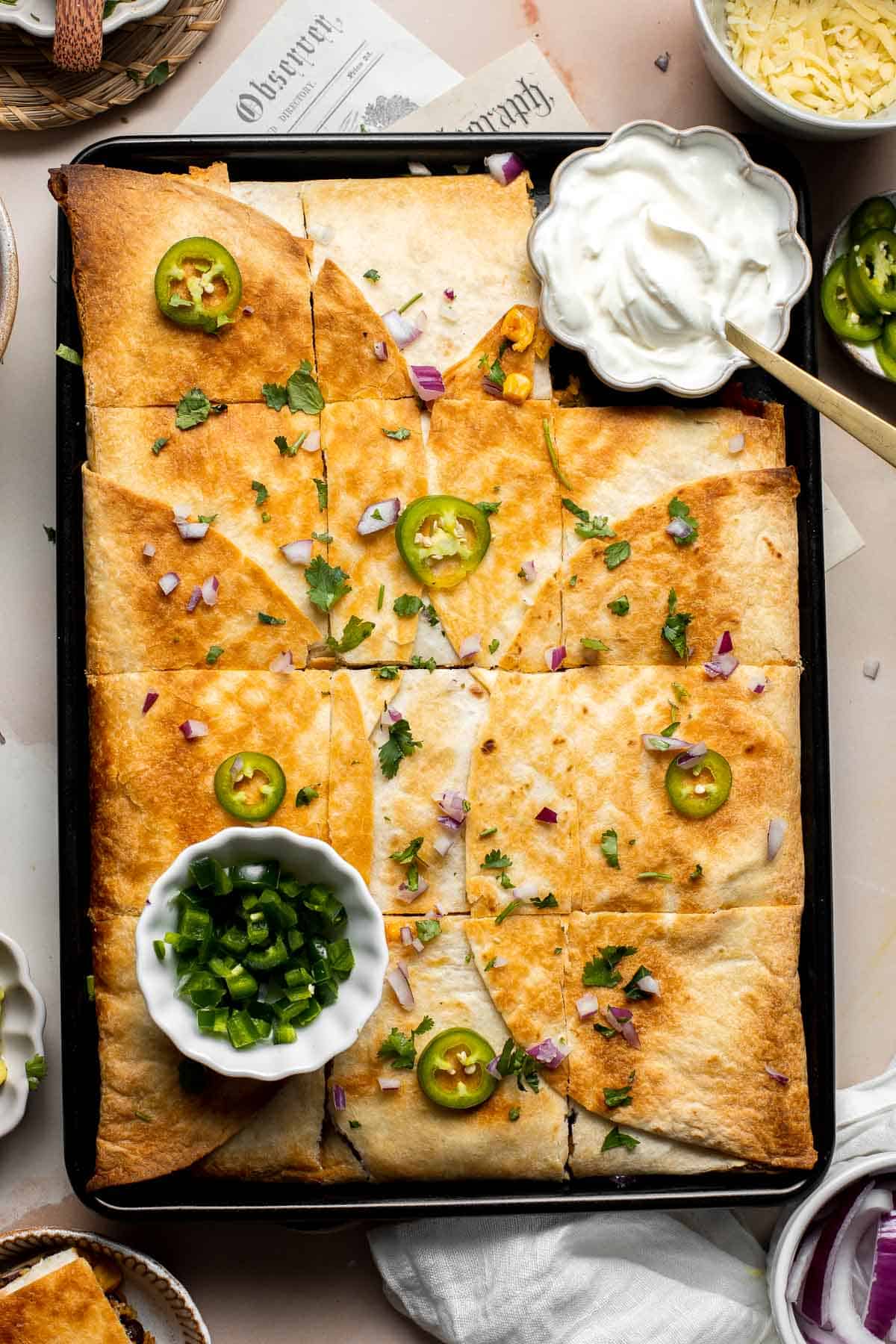 These Sheet Pan Quesadillas are loaded with veggies and gooey cheese, baked in the oven until crispy, and made to feed a crowd in just 30 minutes. | aheadofthyme.com