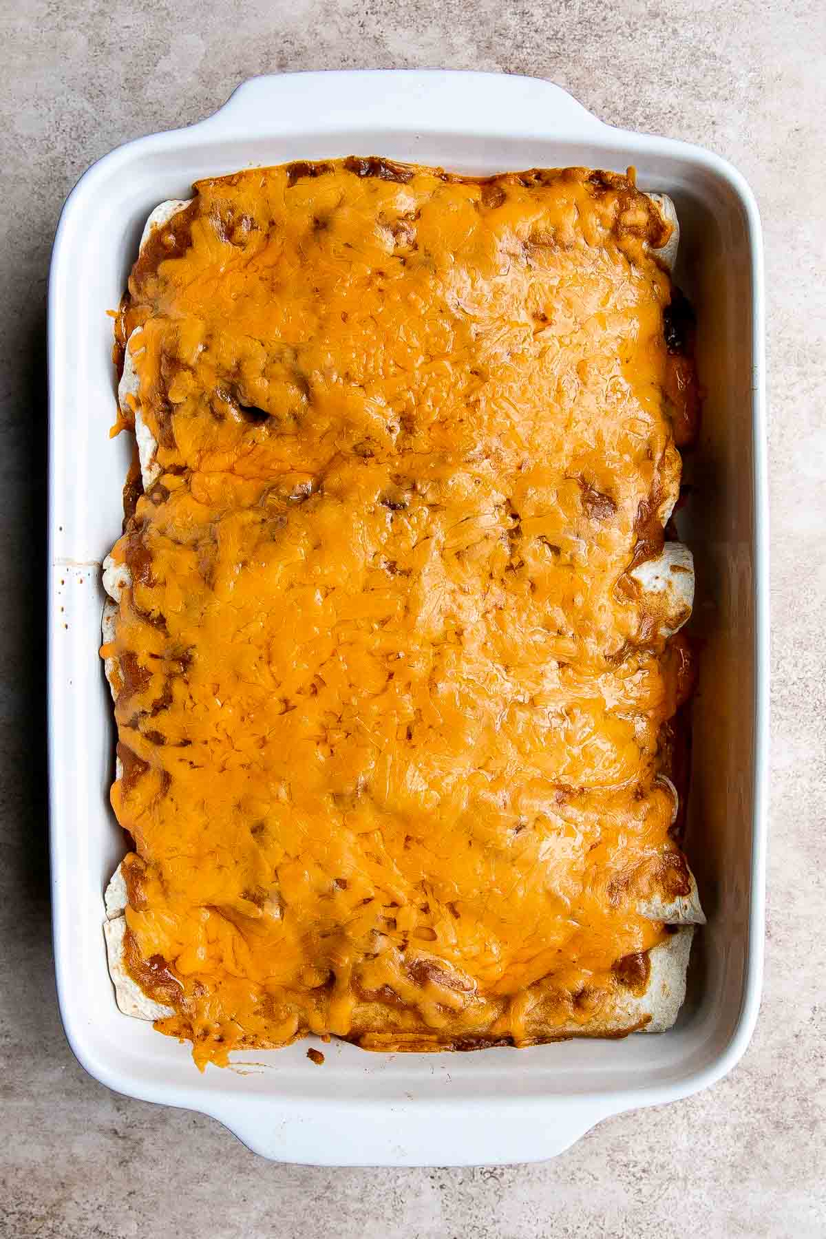 Shredded Beef Enchiladas are flavorful, saucy, and cheesy. They are easy to make for family dinner using just a few ingredients including leftover beef. | aheadofthyme.com