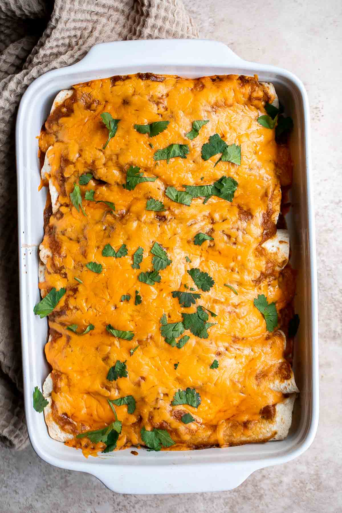 Shredded Beef Enchiladas are flavorful, saucy, and cheesy. They are easy to make for family dinner using just a few ingredients including leftover beef. | aheadofthyme.com