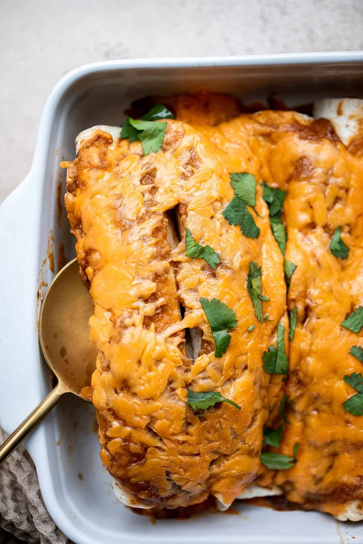 Shredded Beef Enchiladas are flavorful, saucy, and cheesy. They are easy to make for family dinner using just a few ingredients including leftover beef. | aheadofthyme.com