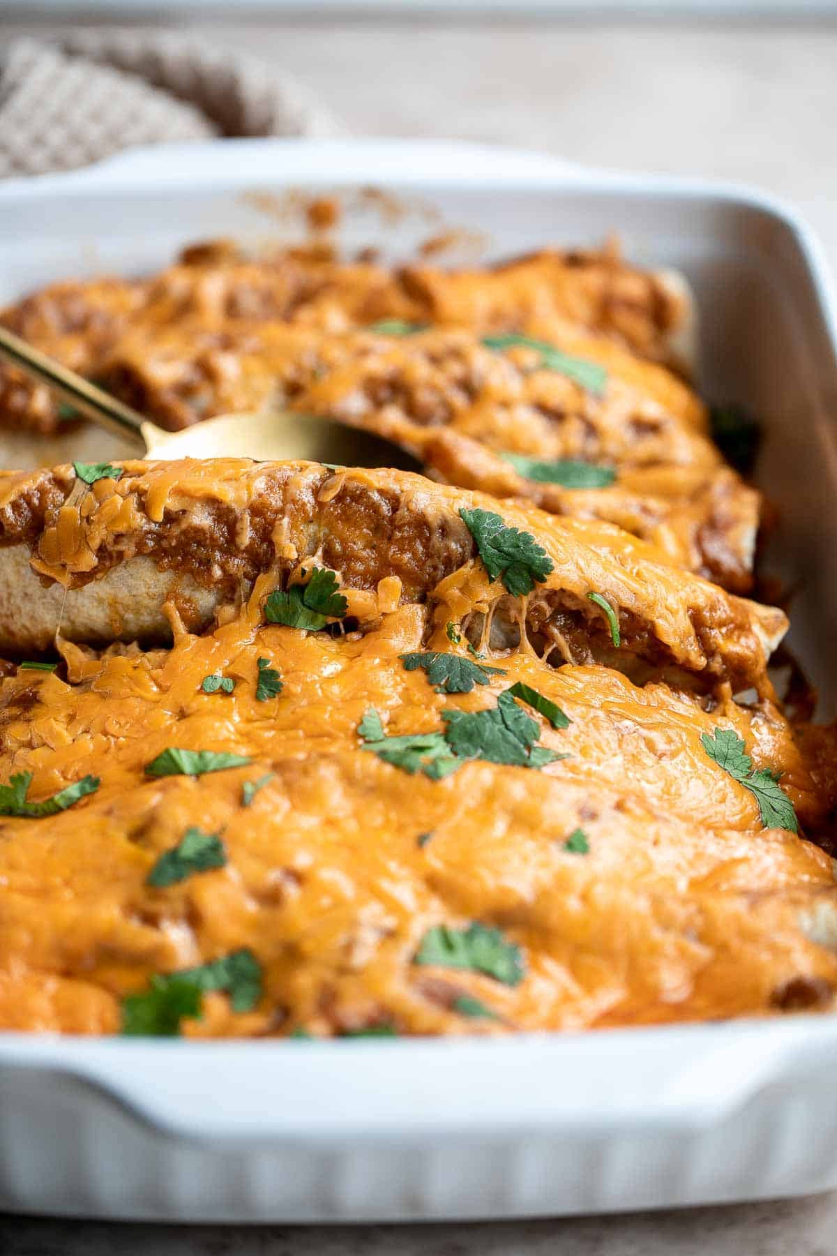 Shredded Beef Enchiladas are flavorful, saucy, and cheesy. They are easy to make for family dinner using just a few ingredients including leftover beef. | aheadofthyme.com