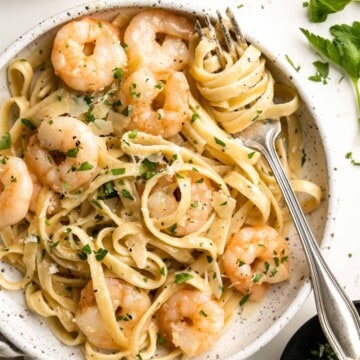 Shrimp Alfredo is creamy, garlicky, and delicious! This quick and easy, under 30-minute recipe is a go-to for busy nights and a year-round family favorite. | aheadofthyme.com