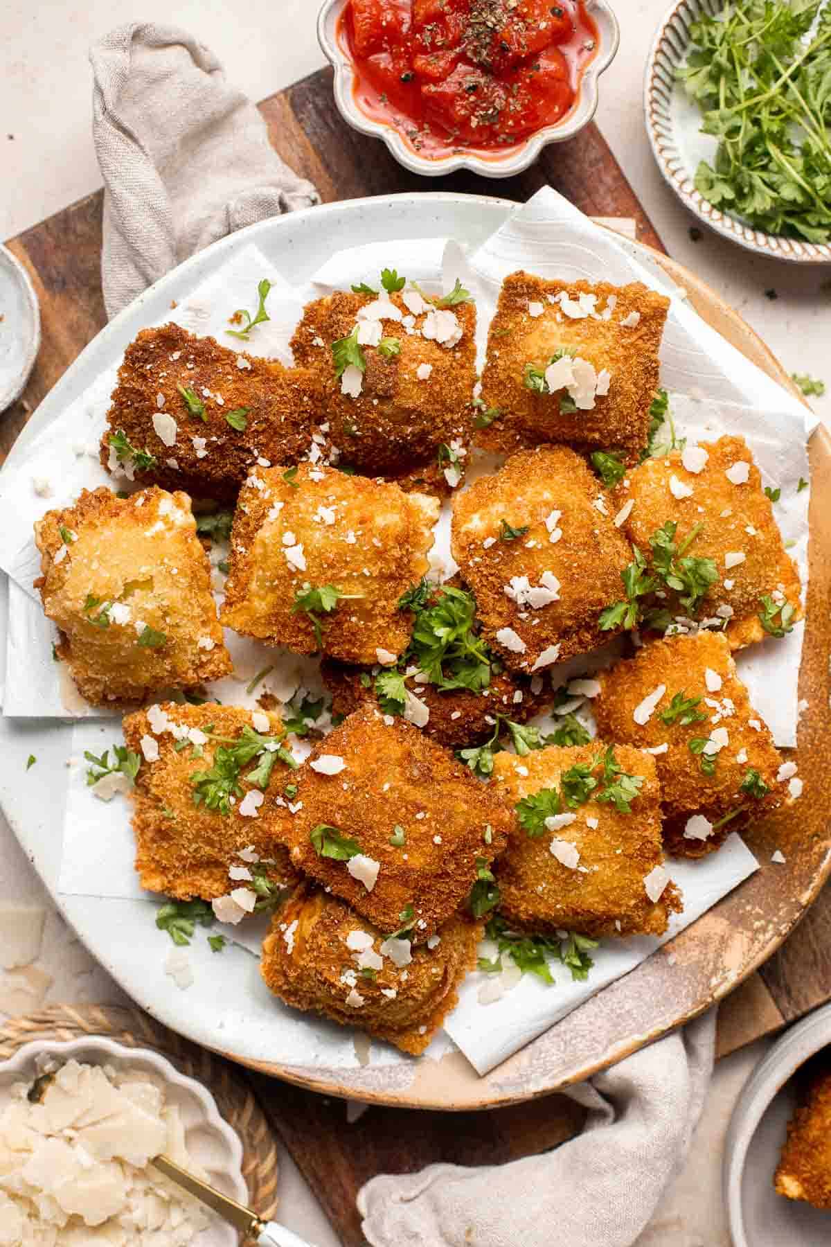 Toasted Ravioli is a classic Italian appetizer that is crispy and golden on the outside, and tender and gooey on the inside. Ready in less than 30 minutes! | aheadofthyme.com