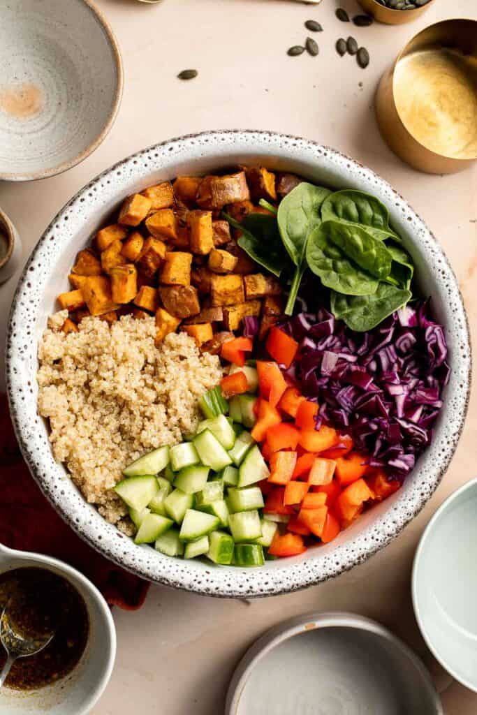 This vegan Buddha Bowl is the perfect hybrid of a salad and grain bowl that is packed with nutritious ingredients like grains, vegetables, and protein. | aheadofthyme.com