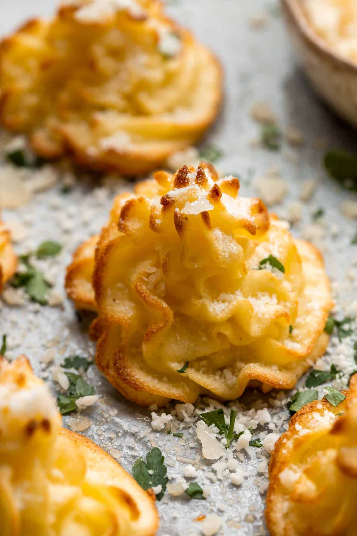 Duchess Potatoes (Pommes Duchesse) are rich, creamy whipped bites of potatoes with crispy edges and a soft fluffy mashed potato centre. A fancy side dish! | aheadofthyme.com