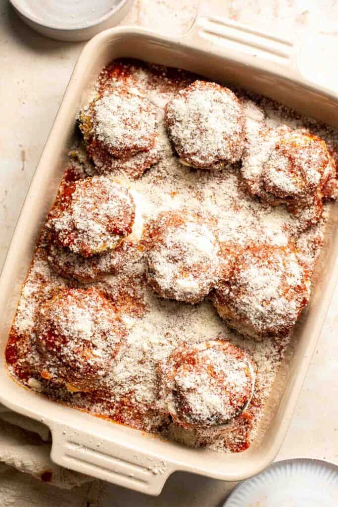 Eggplant Parmesan is a vegetarian Italian dish made featuring tender eggplant slices coated in crispy breadcrumbs, melty cheese, and baked in tomato sauce. | aheadofthyme.com