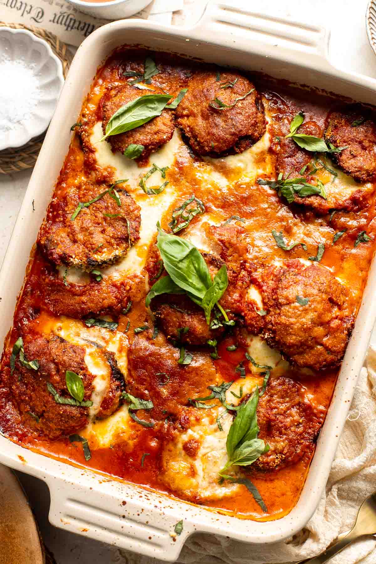 Eggplant Parmesan is a vegetarian Italian dish made featuring tender eggplant slices coated in crispy breadcrumbs, melty cheese, and baked in tomato sauce. | aheadofthyme.com