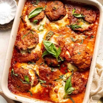 Eggplant Parmesan is a vegetarian Italian dish made featuring tender eggplant slices coated in crispy breadcrumbs, melty cheese, and baked in tomato sauce. | aheadofthyme.com