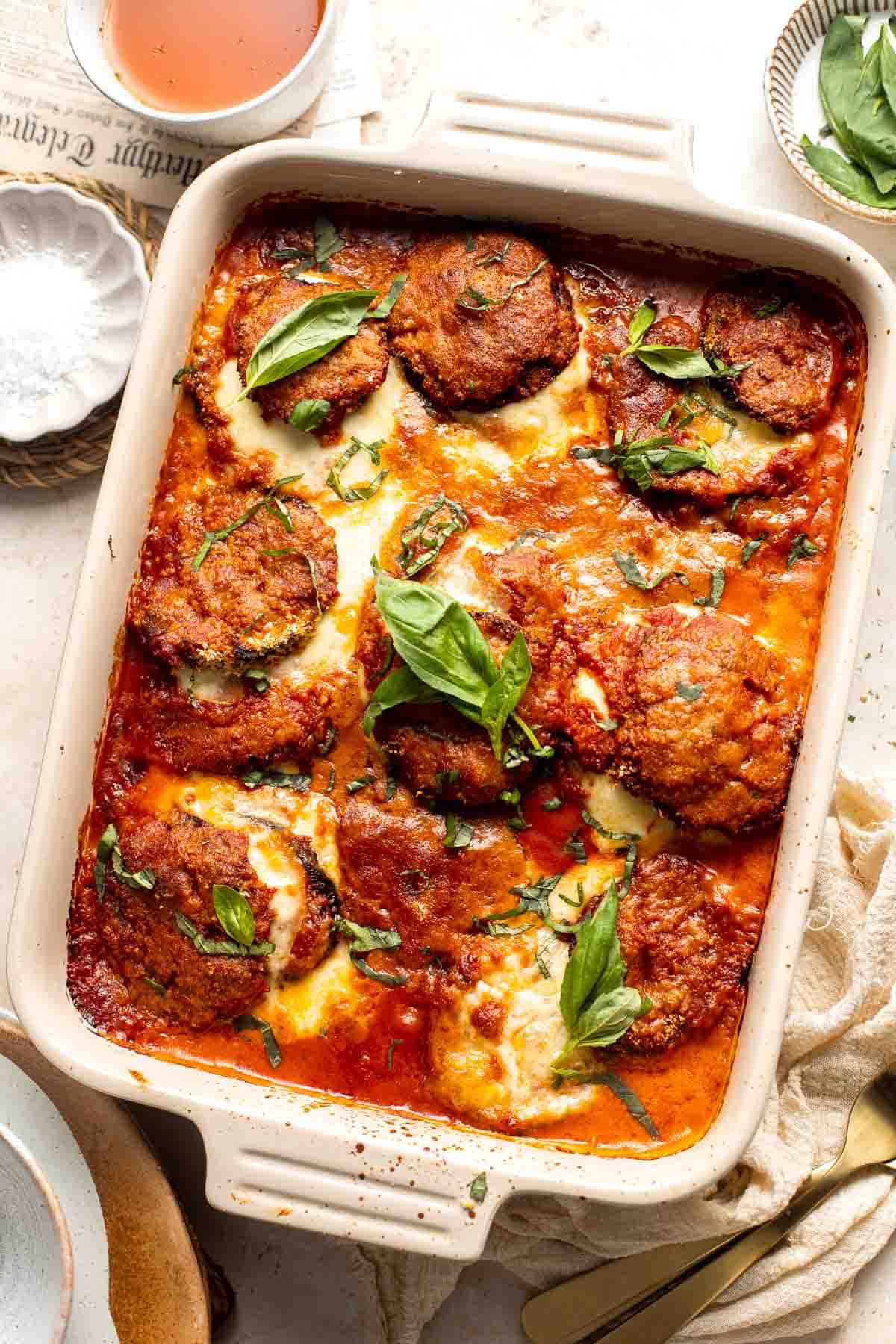 Eggplant Parmesan is a vegetarian Italian dish made featuring tender eggplant slices coated in crispy breadcrumbs, melty cheese, and baked in tomato sauce. | aheadofthyme.com