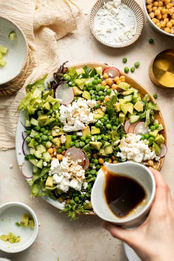 This Spring Salad is light, fresh, and vibrant. It is packed with fresh seasonal vegetables and chickpeas tossed in a homemade honey balsamic dressing. | aheadofthyme.com