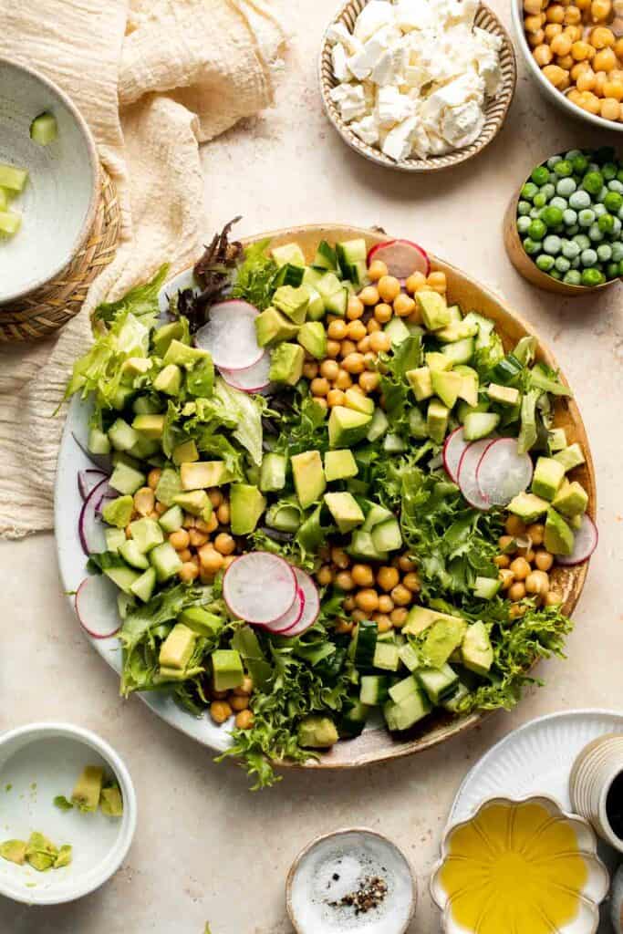 This Spring Salad is light, fresh, and vibrant. It is packed with fresh seasonal vegetables and chickpeas tossed in a homemade honey balsamic dressing. | aheadofthyme.com