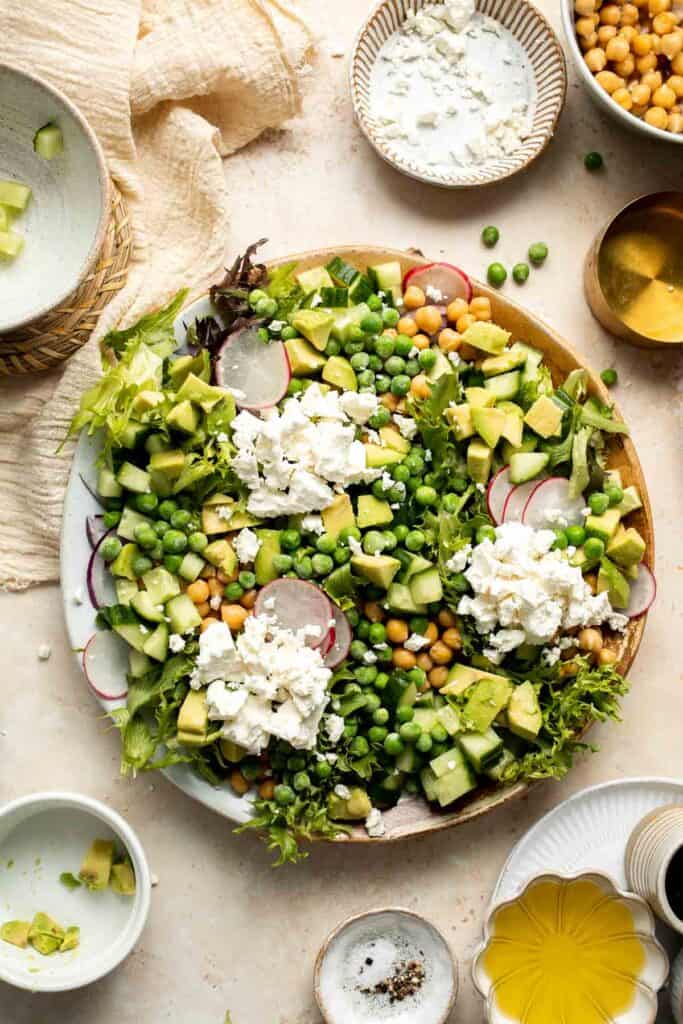 This Spring Salad is light, fresh, and vibrant. It is packed with fresh seasonal vegetables and chickpeas tossed in a homemade honey balsamic dressing. | aheadofthyme.com