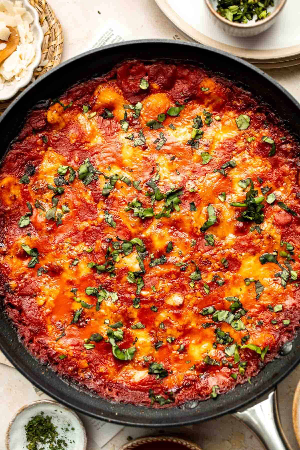Cheesy Baked Gnocchi is quick and easy comfort food made all in one pot with chewy bites of gnocchi, a simple tomato-based sauce, and gooey melty cheese. | aheadofthyme.com