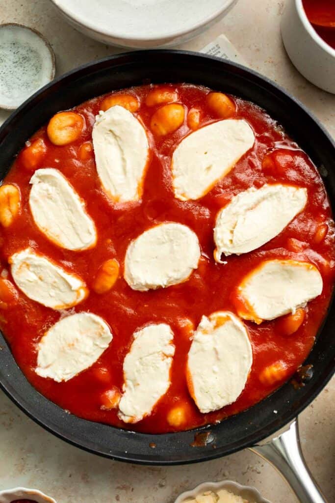 Cheesy Baked Gnocchi is quick and easy comfort food made all in one pot with chewy bites of gnocchi, a simple tomato-based sauce, and gooey melty cheese. | aheadofthyme.com