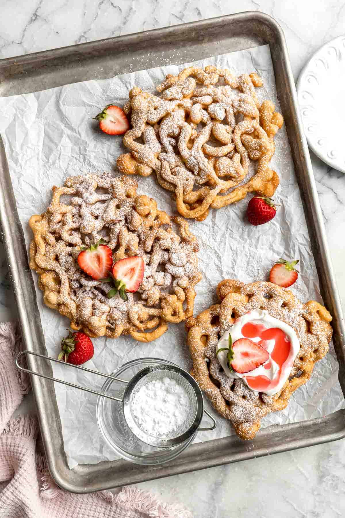 There’s truly nothing like a homemade Funnel Cake: a crispy jumble of crispy vanilla-tinged batter fried and topped with a powdered sugar, and served warm. | aheadofthyme.com