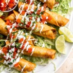Homemade Taquitos are crispy, delicious and flavorful. These rolled tacos are filled with seasoned ground beef and melty cheese — and can be fried or baked! | aheadofthyme.com