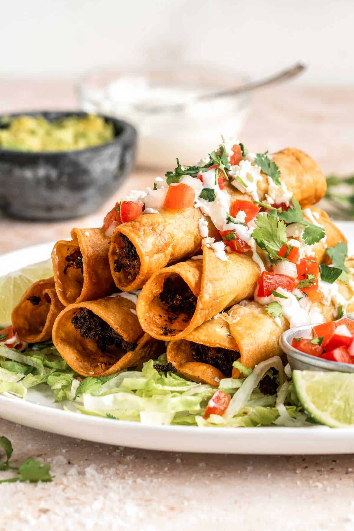 Homemade Taquitos are crispy, delicious and flavorful. These rolled tacos are filled with seasoned ground beef and melty cheese — and can be fried or baked! | aheadofthyme.com