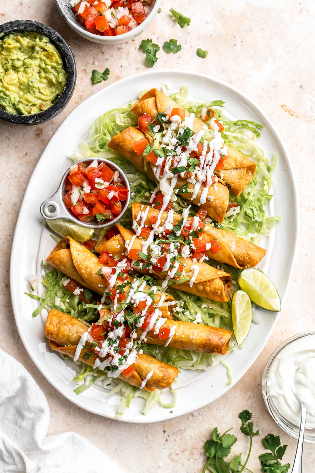 Homemade Taquitos are crispy, delicious and flavorful. These rolled tacos are filled with seasoned ground beef and melty cheese — and can be fried or baked! | aheadofthyme.com