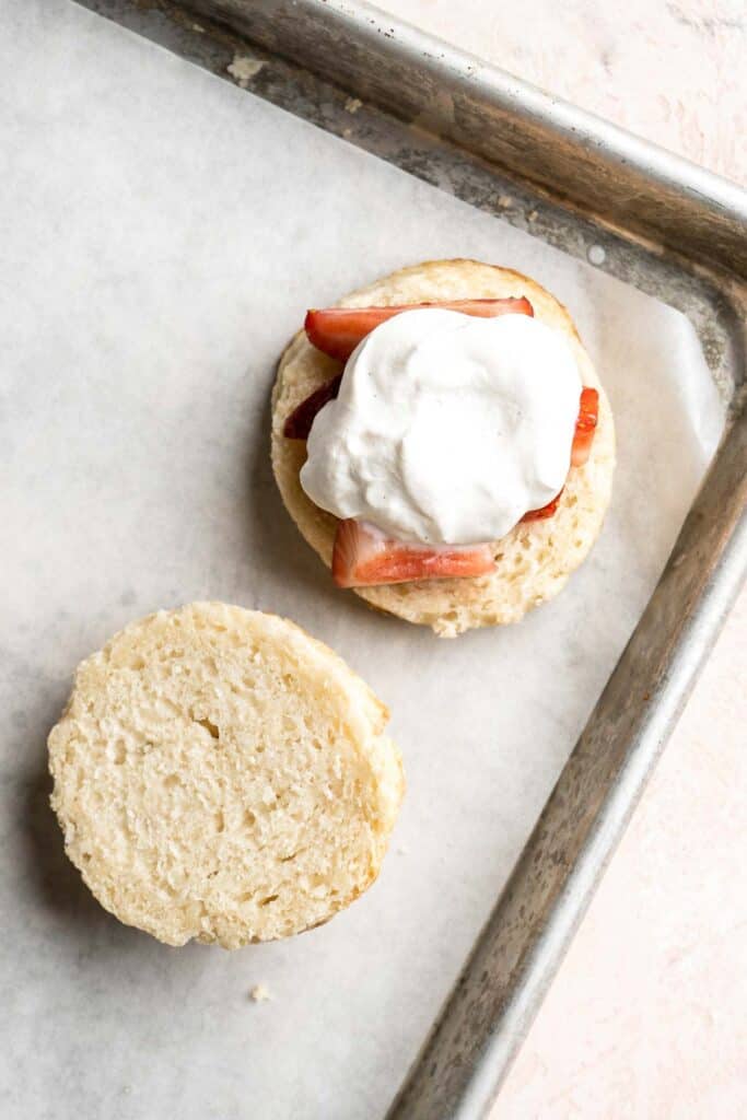 Classic Strawberry Shortcake is a small, layered cake featuring fluffy crumbly biscuits, a fresh strawberry filling, and homemade whipped cream. | aheadofthyme.com