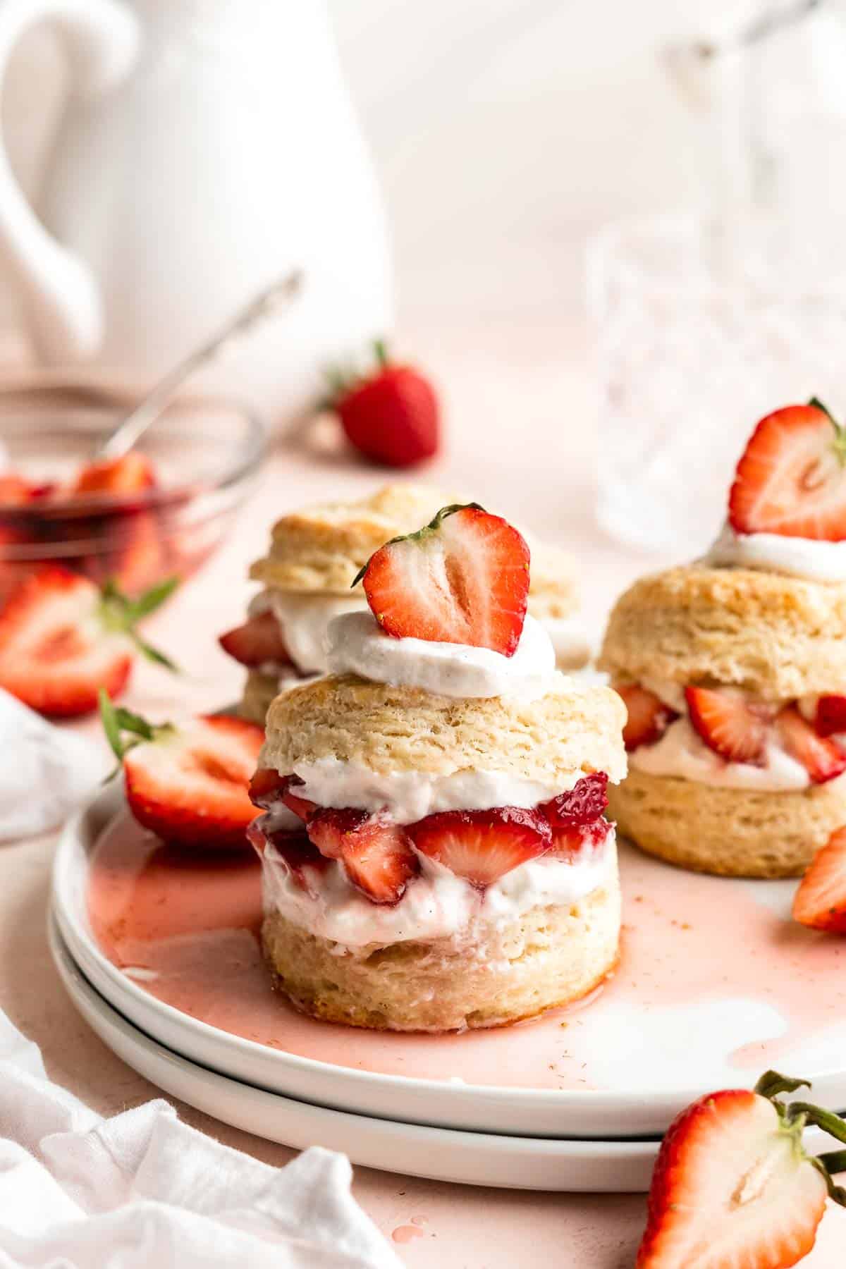 Classic Strawberry Shortcake is a small, layered cake featuring fluffy crumbly biscuits, a fresh strawberry filling, and homemade whipped cream. | aheadofthyme.com