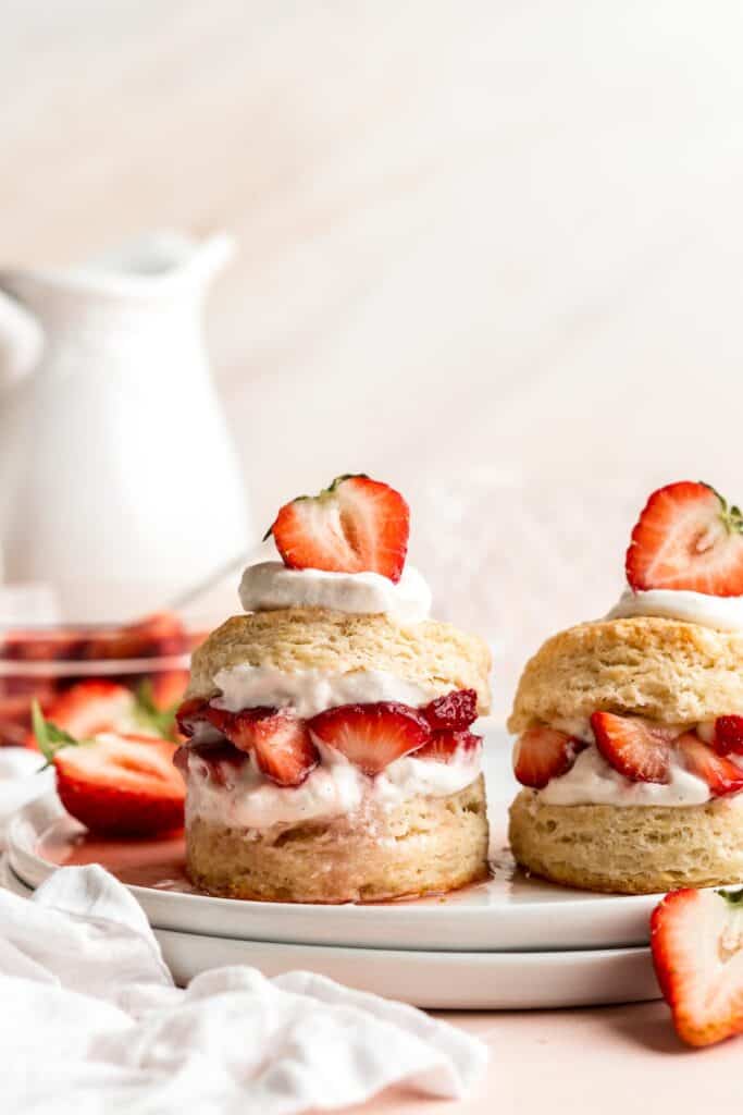 Classic Strawberry Shortcake is a small, layered cake featuring fluffy crumbly biscuits, a fresh strawberry filling, and homemade whipped cream. | aheadofthyme.com