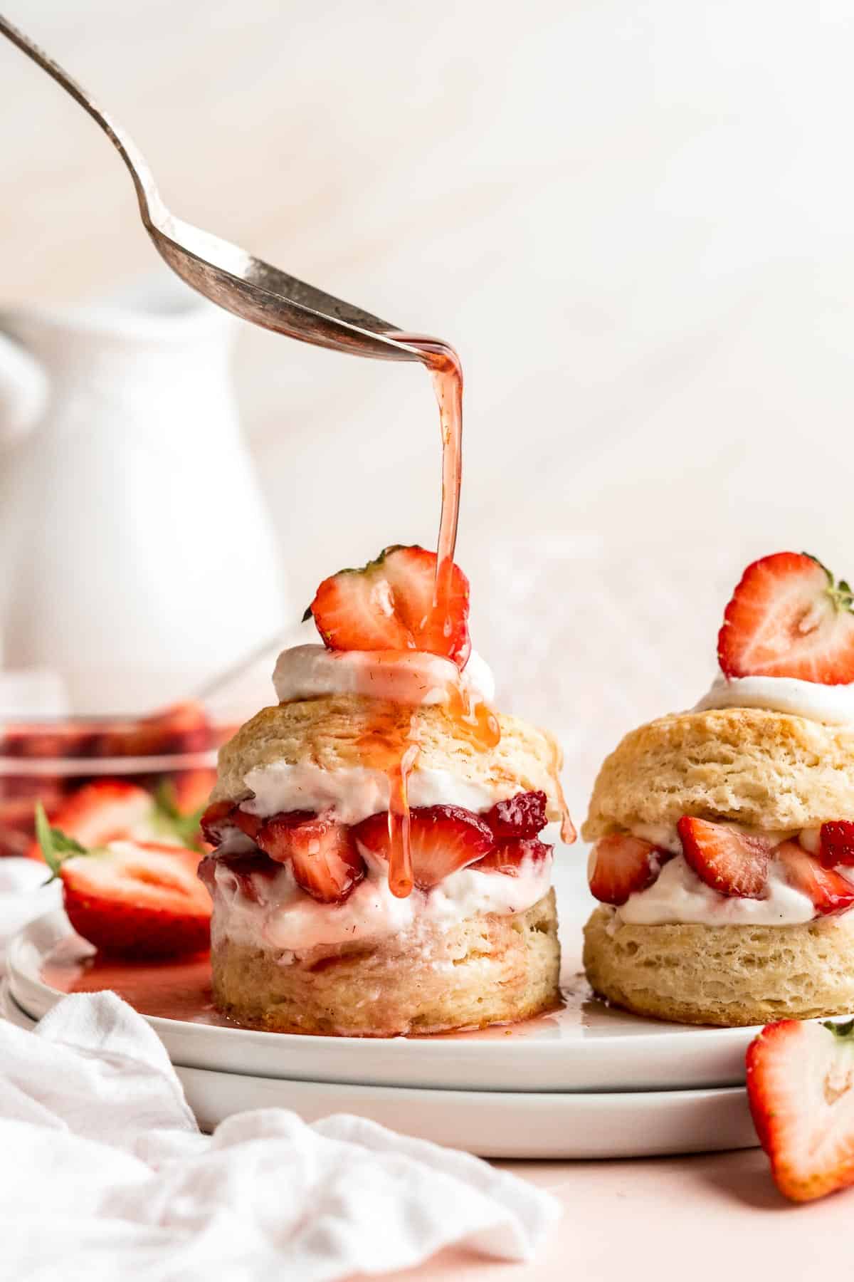 Classic Strawberry Shortcake is a small, layered cake featuring fluffy crumbly biscuits, a fresh strawberry filling, and homemade whipped cream. | aheadofthyme.com