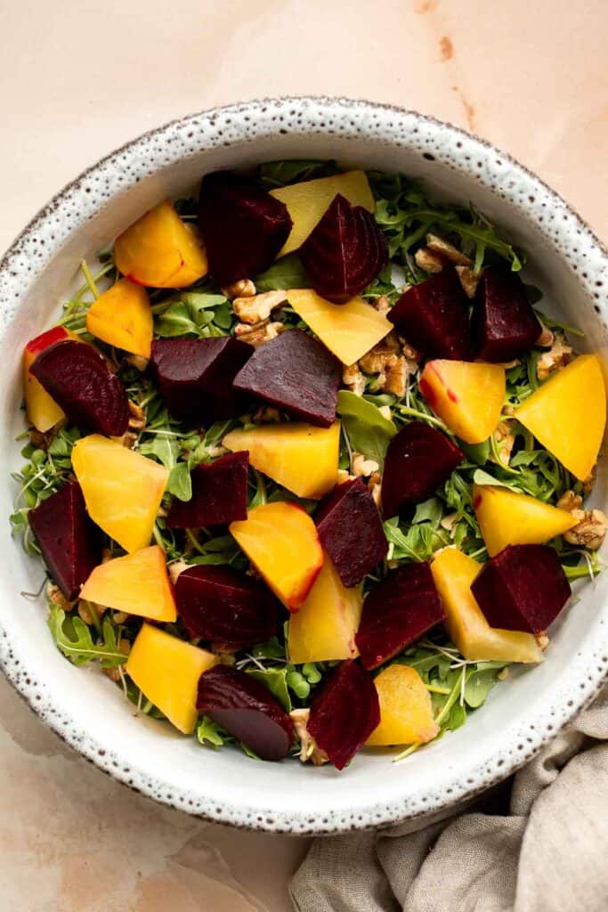 Beet Salad is a light, fresh, and vibrant salad packed with nutrients. It is loaded with beets, greens, feta, and walnuts, tossed in a homemade vinaigrette. | aheadofthyme.com