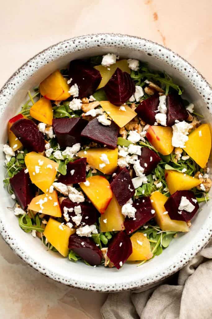 Beet Salad is a light, fresh, and vibrant salad packed with nutrients. It is loaded with beets, greens, feta, and walnuts, tossed in a homemade vinaigrette. | aheadofthyme.com