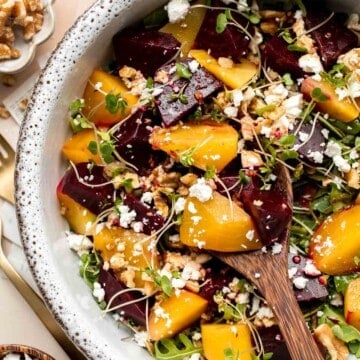 Beet Salad is a light, fresh, and vibrant salad packed with nutrients. It is loaded with beets, greens, feta, and walnuts, tossed in a homemade vinaigrette. | aheadofthyme.com