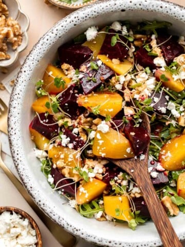 Beet Salad is a light, fresh, and vibrant salad packed with nutrients. It is loaded with beets, greens, feta, and walnuts, tossed in a homemade vinaigrette. | aheadofthyme.com