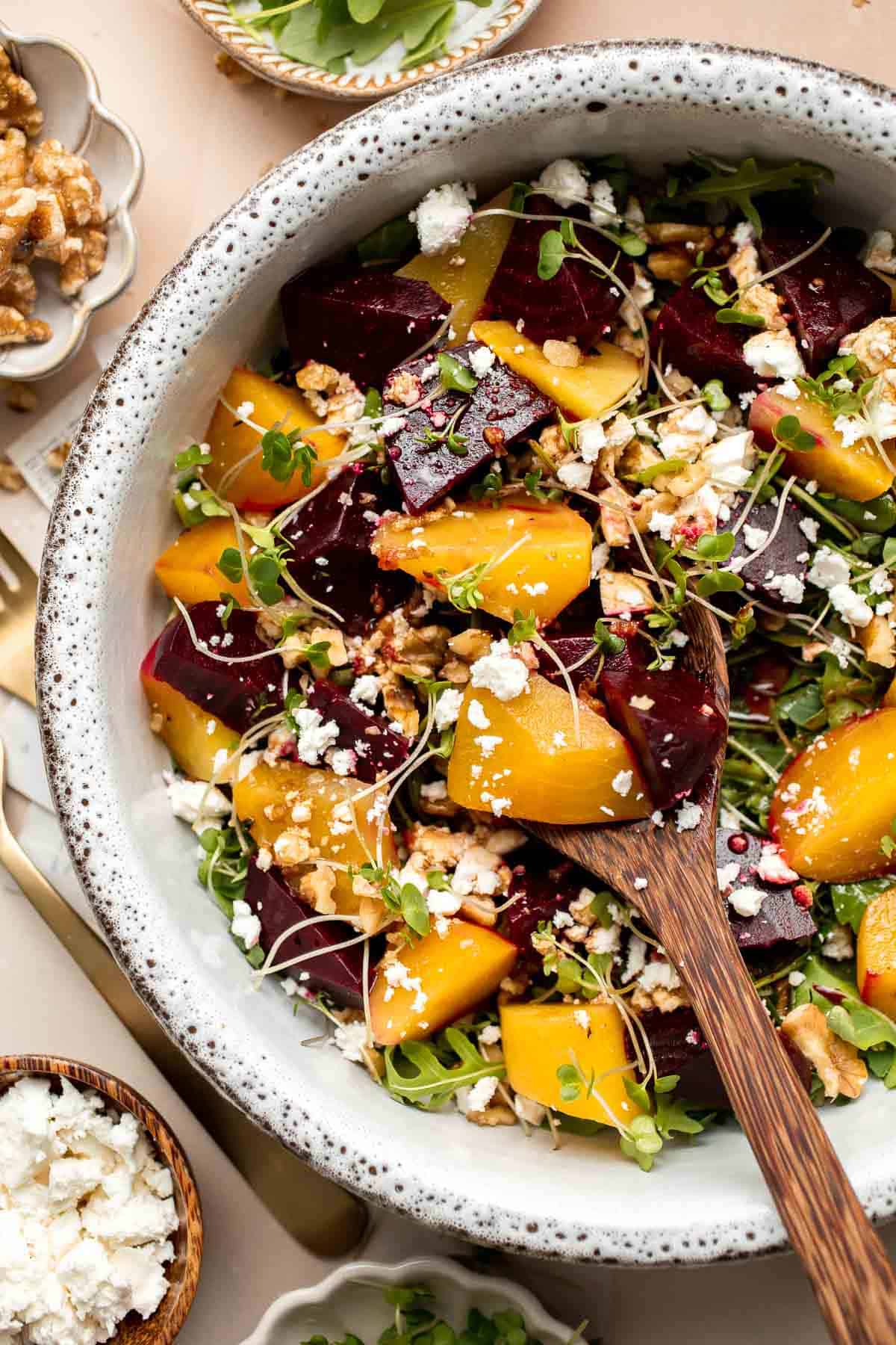 Beet Salad is a light, fresh, and vibrant salad packed with nutrients. It is loaded with beets, greens, feta, and walnuts, tossed in a homemade vinaigrette. | aheadofthyme.com