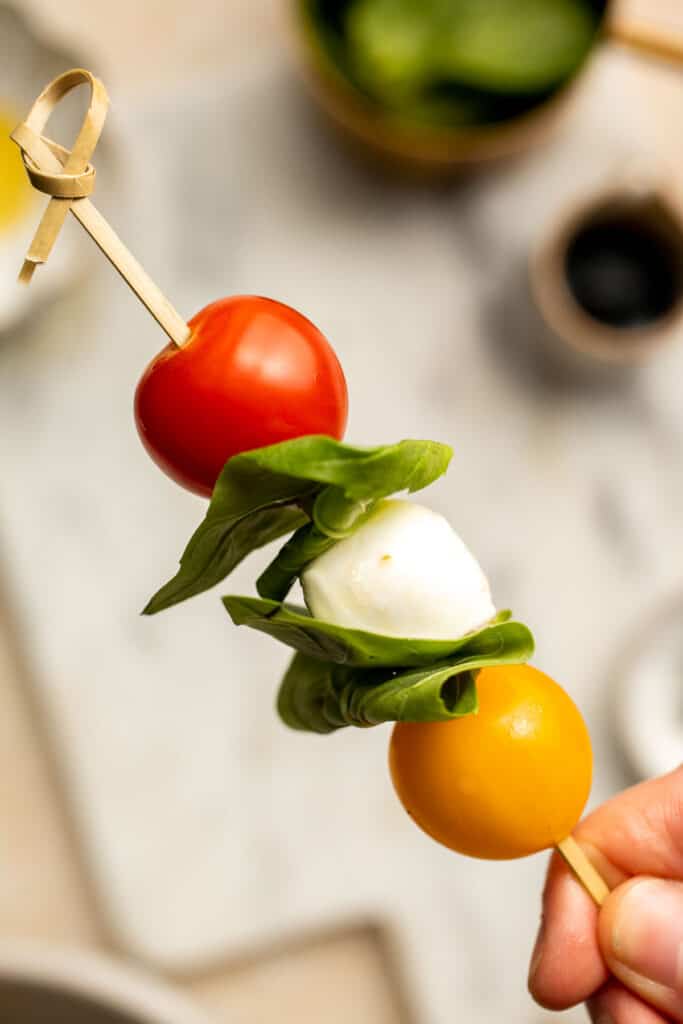 Caprese Skewers are a quick and fresh appetizer made with bite-sized mozzarella, juicy tomatoes, and basil leaves with a drizzle of balsamic glaze. | aheadofthyme.com