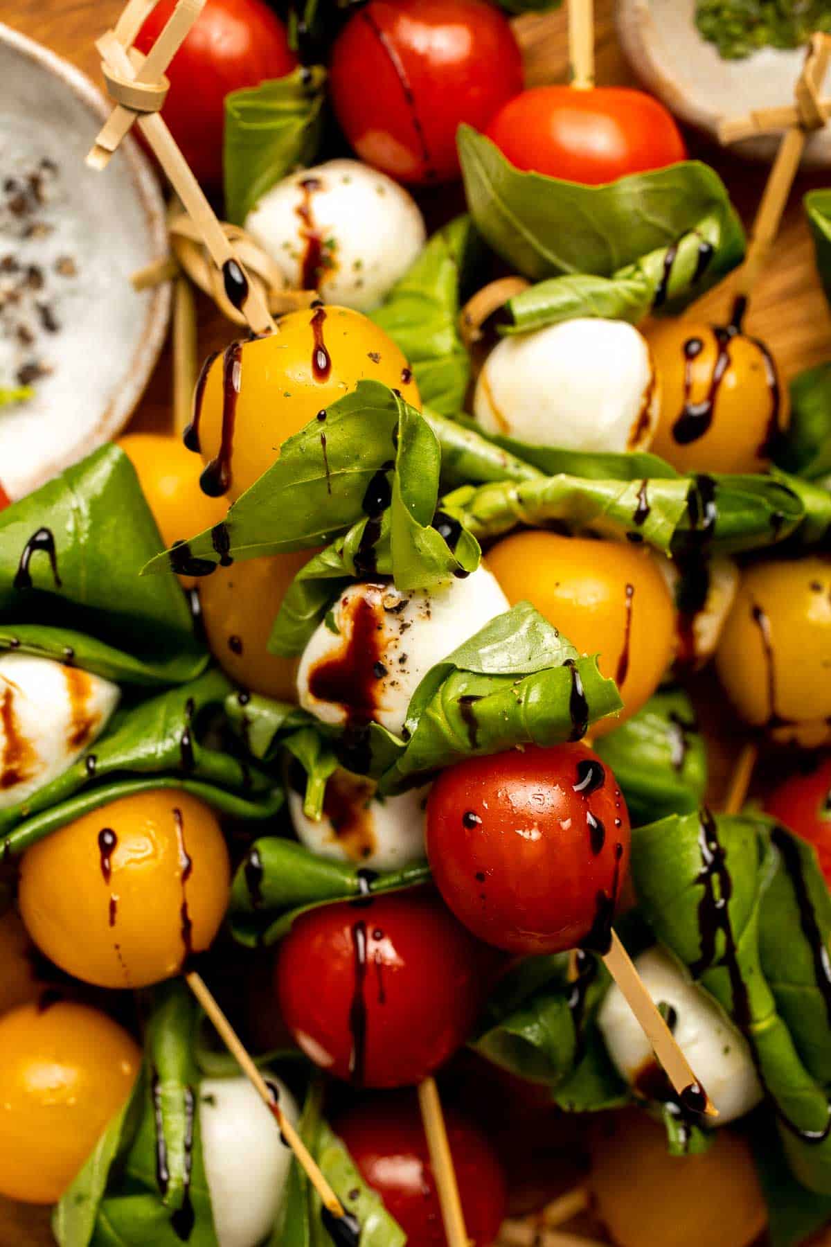 Caprese Skewers are a quick and fresh appetizer made with bite-sized mozzarella, juicy tomatoes, and basil leaves with a drizzle of balsamic glaze. | aheadofthyme.com