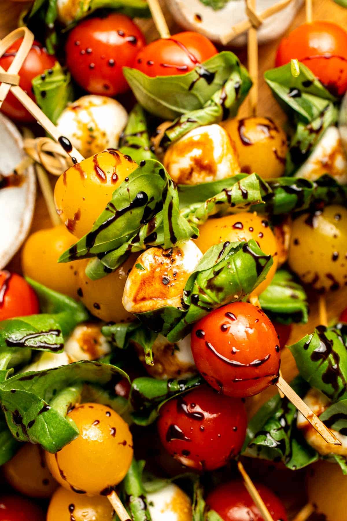 Caprese Skewers are a quick and fresh appetizer made with bite-sized mozzarella, juicy tomatoes, and basil leaves with a drizzle of balsamic glaze. | aheadofthyme.com