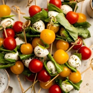 Caprese Skewers are a quick and fresh appetizer made with bite-sized mozzarella, juicy tomatoes, and basil leaves with a drizzle of balsamic glaze. | aheadofthyme.com