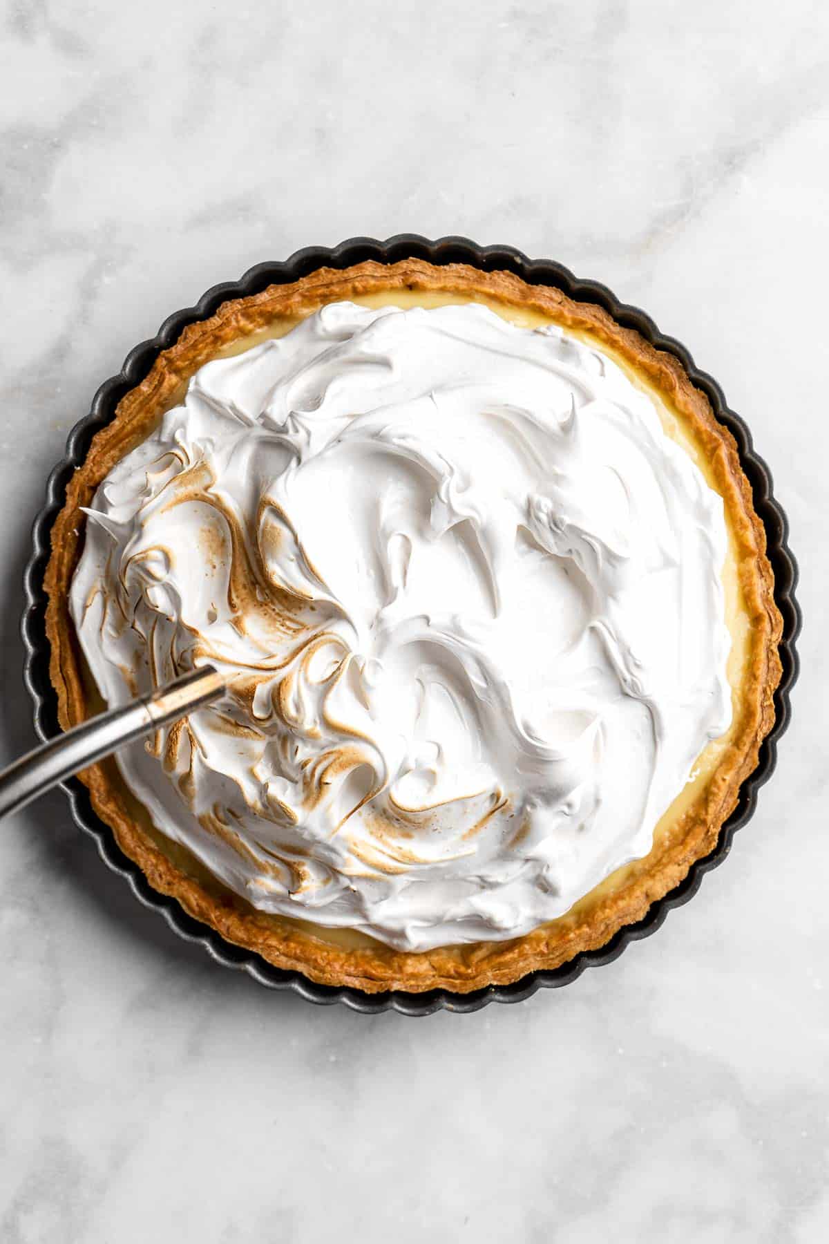 Lemon Meringue Pie made with delicate peaks of golden-brown meringue, creamy and tart lemon curd filling, and flaky pie crust is the best homemade pie ever! | aheadofthyme.com