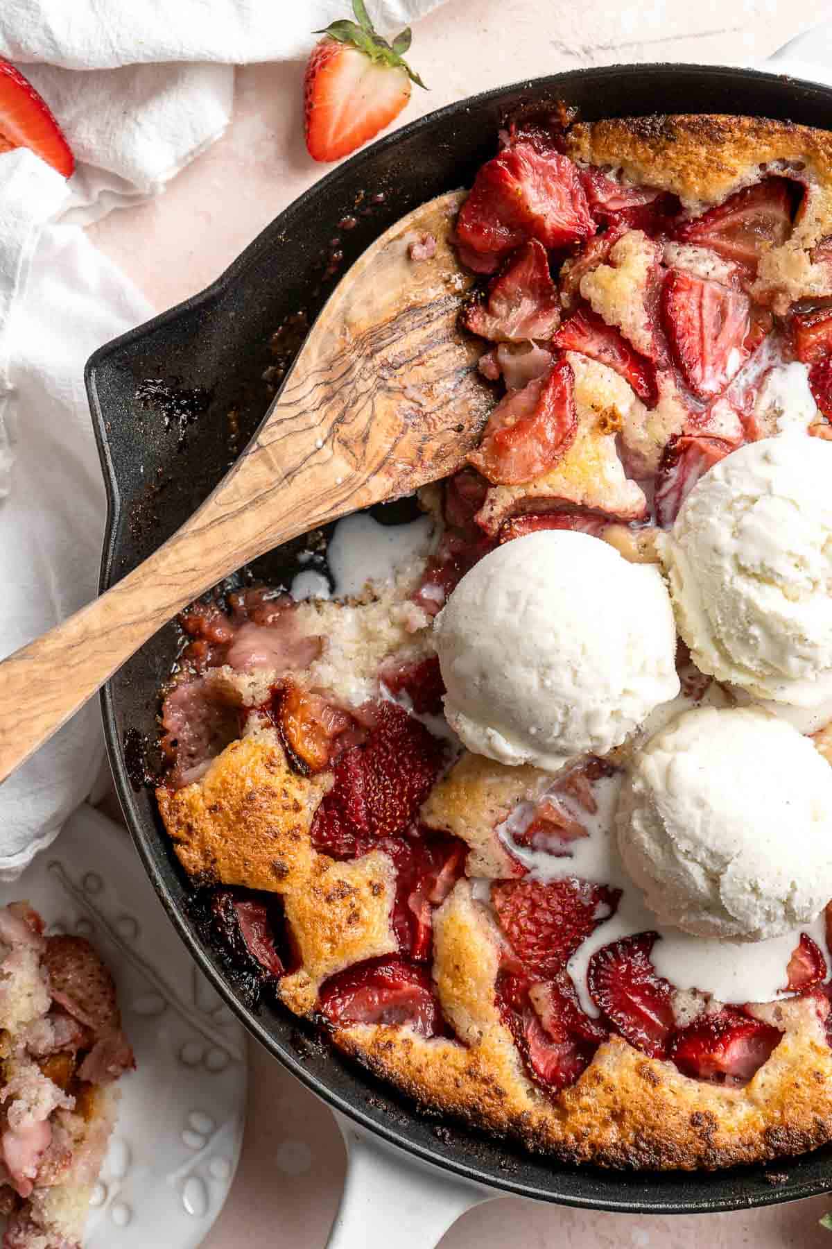Strawberry Cobbler made with sweet, gooey strawberries and light, fluffy cakey batter is an easy summer dessert to make from scratch with 10 minutes prep. | aheadofthyme.com