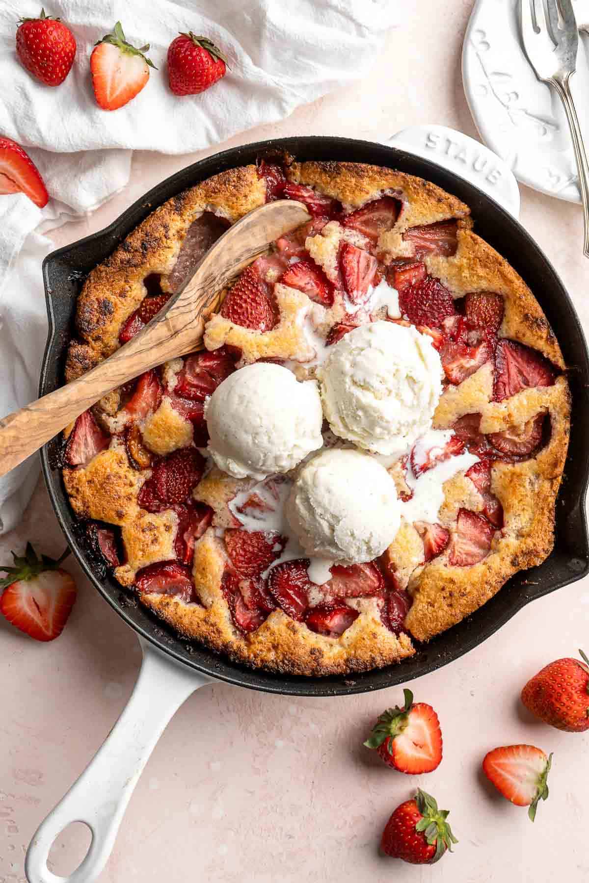 Strawberry Cobbler made with sweet, gooey strawberries and light, fluffy cakey batter is an easy summer dessert to make from scratch with 10 minutes prep. | aheadofthyme.com