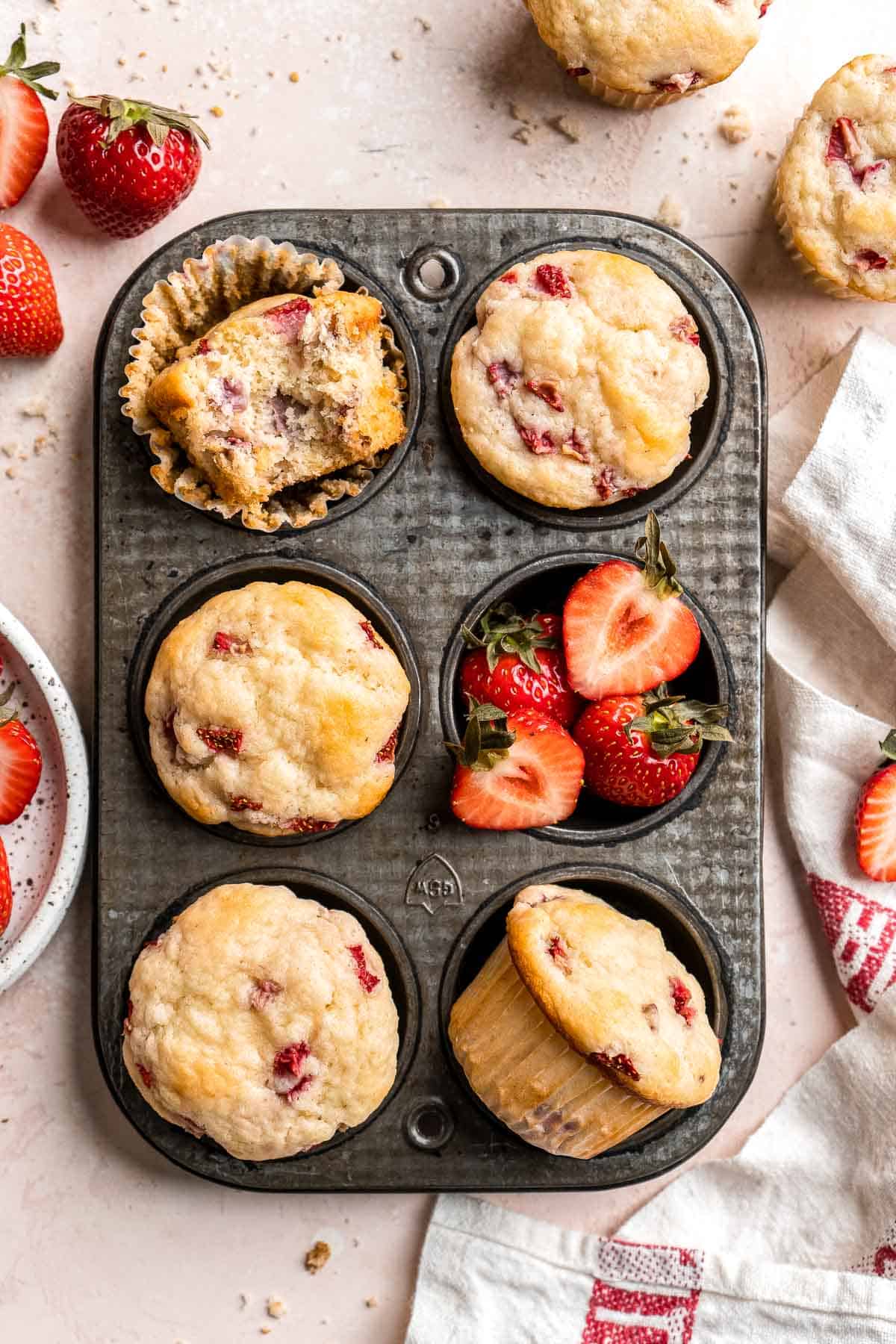 Strawberry Muffins are tender, fluffy, and delicious! They are golden-brown and crisp outside while moist and cake-like inside and loaded with strawberries. | aheadofthyme.com
