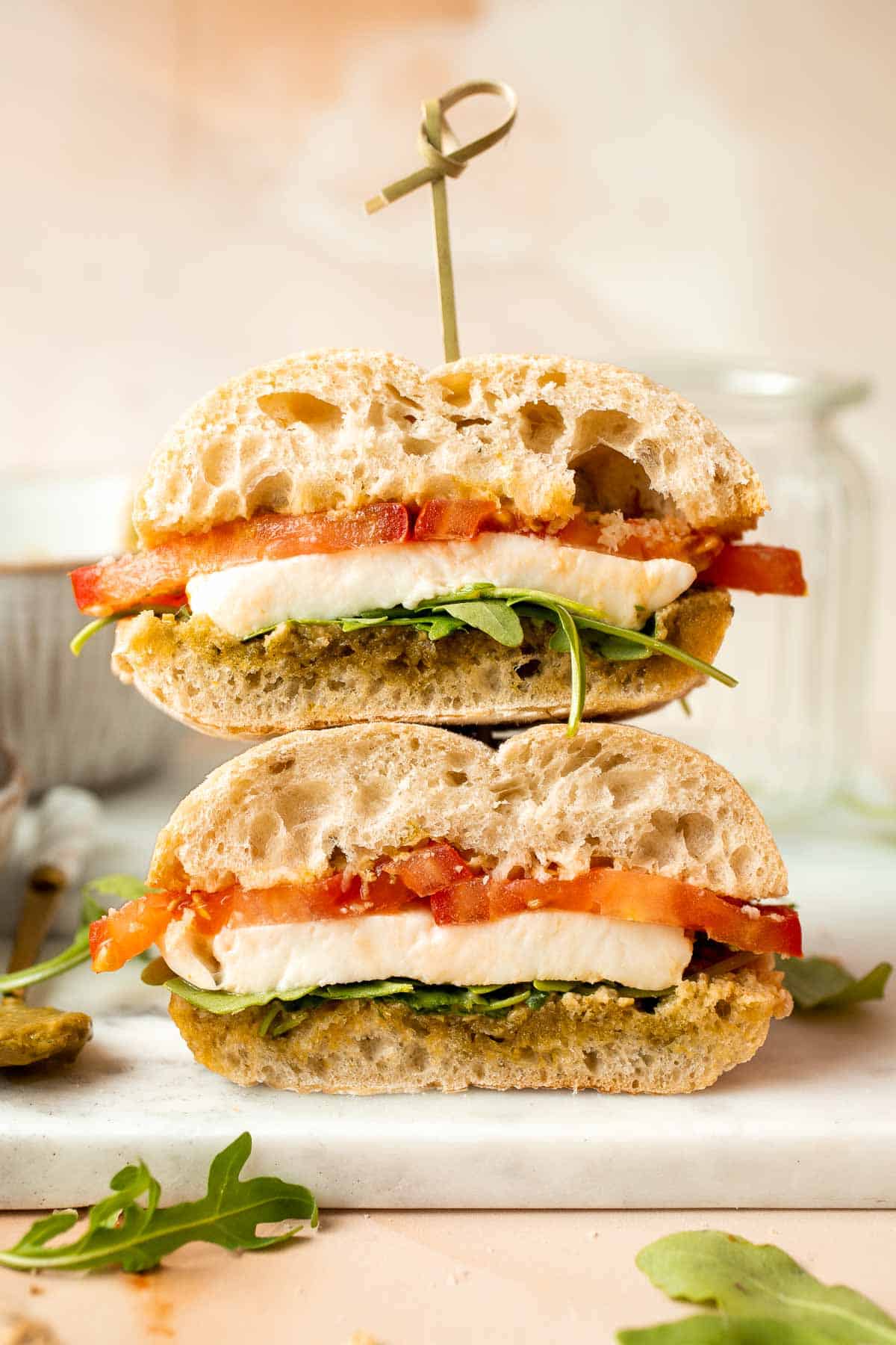 This vegetarian Caprese Sandwich is packed with layers of fresh tomatoes, mozzarella, greens, and a balsamic basil pesto sauce in between ciabatta buns. | aheadofthyme.com