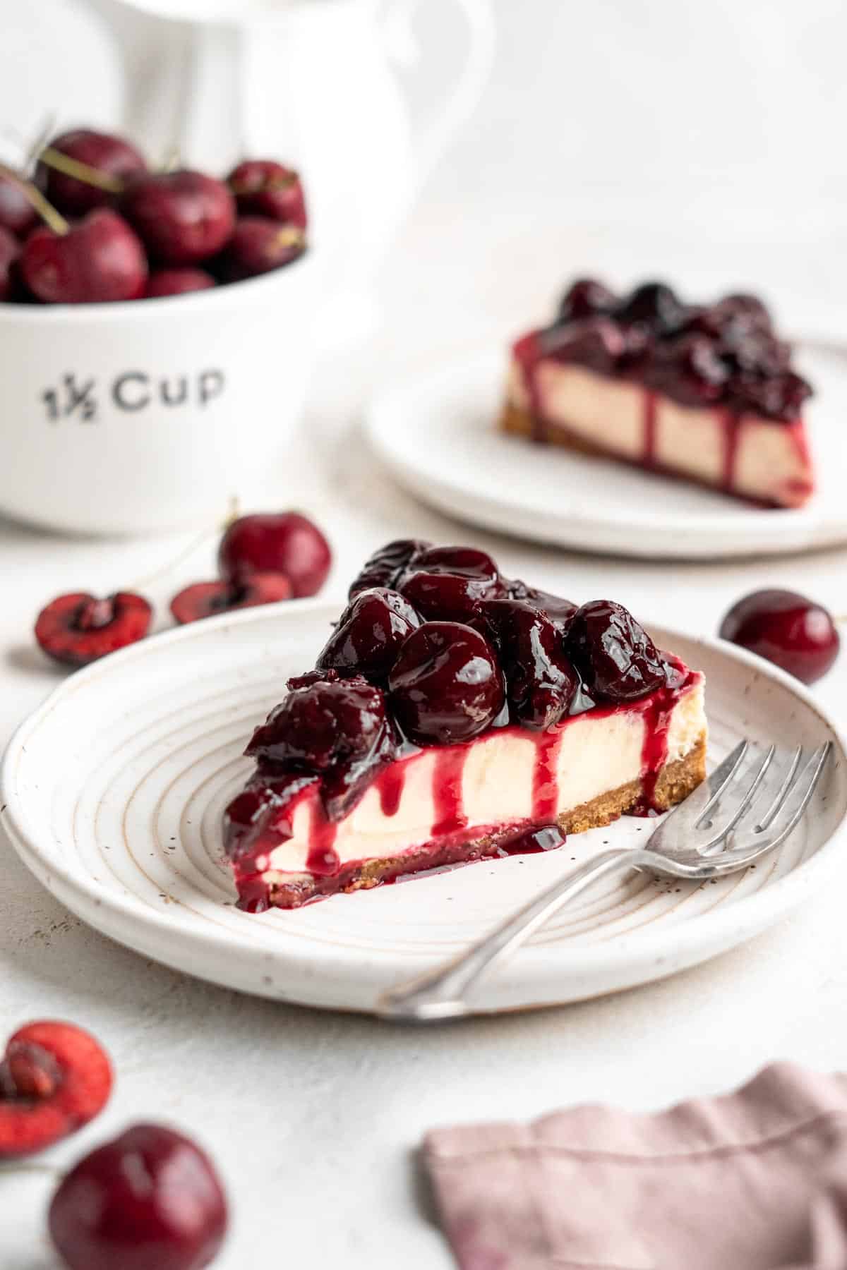 Cherry Cheesecake is lush, velvety, and creamy finished with a heap of sweet homemade cherry sauce on top. The perfect summer dessert with cherries! | aheadofthyme.com