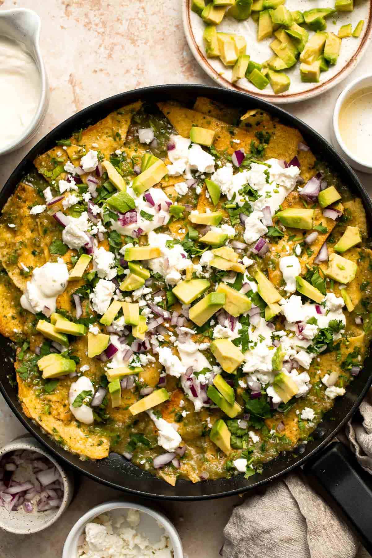 Chilaquiles Verdes feature crispy baked tortilla chips smothered in a homemade sauce loaded with salsa verde and features classic Mexican toppings. | aheadofthyme.com