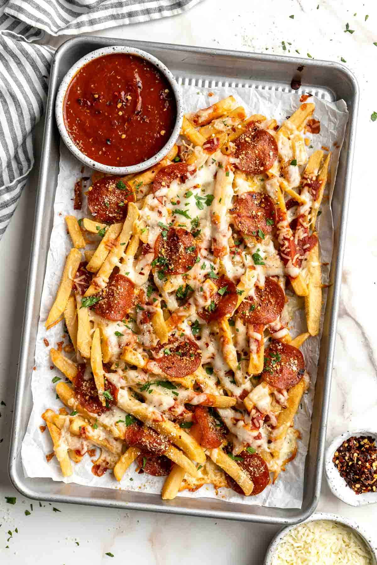 Baked Pizza Fries are loaded with a rich marinara sauce, melted cheese, and crispy pepperoni — transforming ordinary fries into the ultimate finger food. | aheadofthyme.com